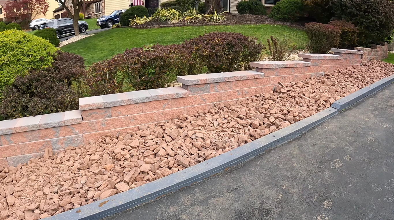 Precision-graded retaining wall with proper drainage and landscaping